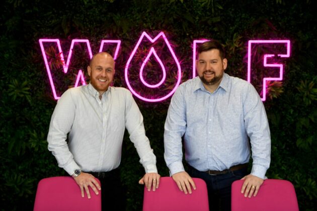 Wolf Directors in front of Wolf Neon Sign