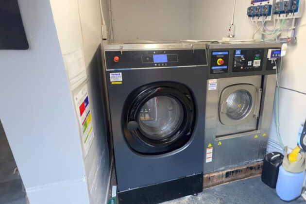 A newly installed Alliance commercial washing machine